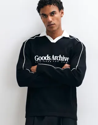 ASOS DESIGN heavyweight relaxed long sleeve polo with piping and text graphic in black waffle fabric