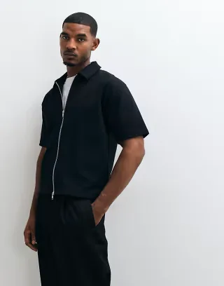 ASOS DESIGN Interlock relaxed boxy polo with zip up in black