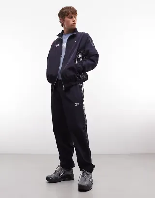 Umbro relaxed track pants in dark blue and white