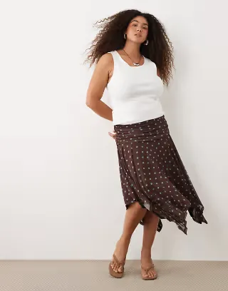 ASOS DESIGN Curve sheer mesh hanky hem skirt in brown polka dot print
