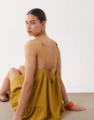 ASOS DESIGN textured halter trapeze mini dress in ocre