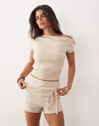The Frolic Exclusive compact knit tie front cinch waist off-shoulder top and shorts set in cream