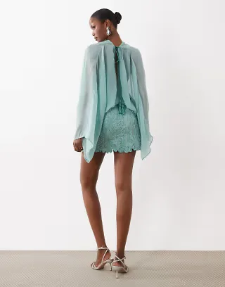 ASOS DESIGN caped open back mini dress with embellished skirt in blue