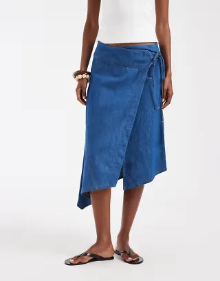 ASOS DESIGN denim asymmetric wrap skirt in mid blue