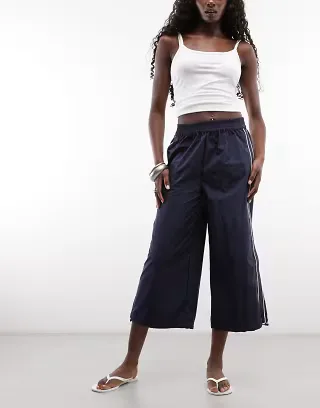 ASOS DESIGN cropped track pants in navy blue with ecru piping