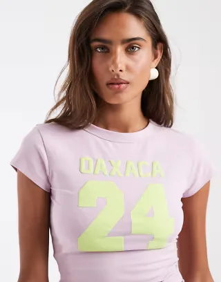 ASOS DESIGN Baby tee with Oaxaca varsity graphic in lilac and lime