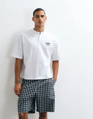 ASOS DESIGN boxy oversized henley t-shirt with chest graphic in white