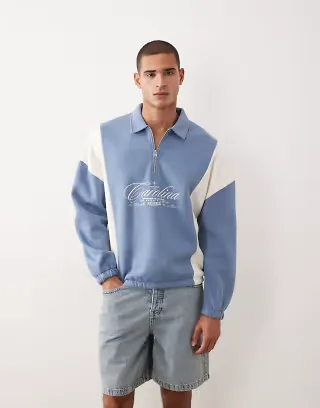 ASOS DESIGN relaxed half zip sweatshirt with cut & sew panels and embroidered print in blue