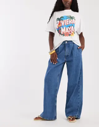ASOS DESIGN pleat front horseshoe jeans in mid wash blue