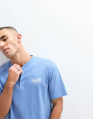 ASOS DESIGN heavyweight boxy relaxed polo with chest text graphic in blue wash