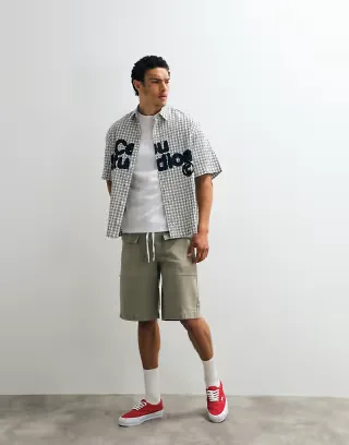 ASOS DESIGN boxy oversized plaid shirt with chest print in black and white