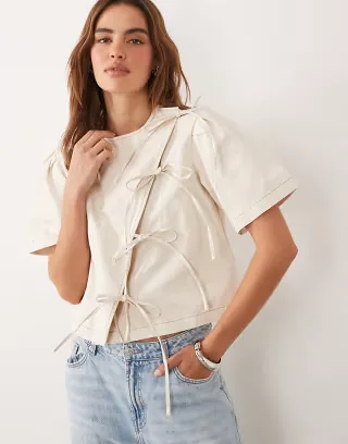 Ghospell cotton asymmetric bow detail boxy short sleeve top in beige