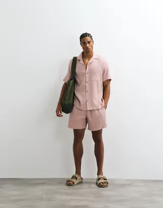 ASOS DESIGN crinkle texture shorts in mid length in pink - part of a set