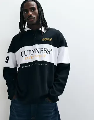 ASOS DESIGN oversized rugby polo with Guinness print in Black