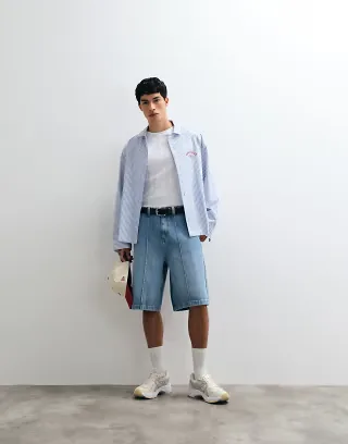 ASOS DESIGN loose longer length jorts with pintucks in mid wash blue