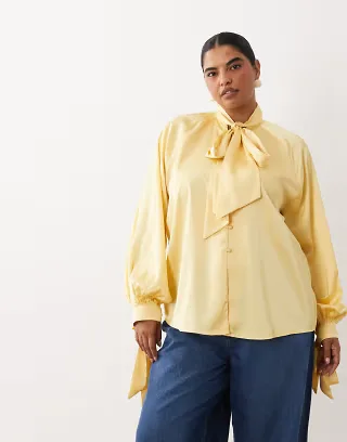 ASOS DESIGN Curve satin tie cuffs tie neck button down blouse in buttermilk