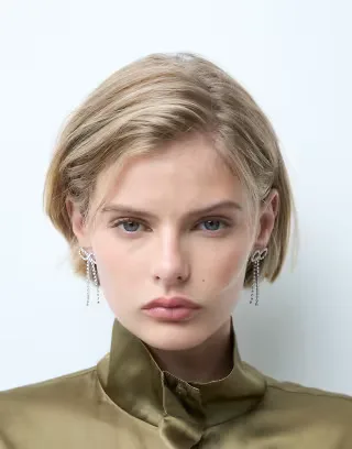 ASOS DESIGN stud earrings with crystal bow design in silver tone