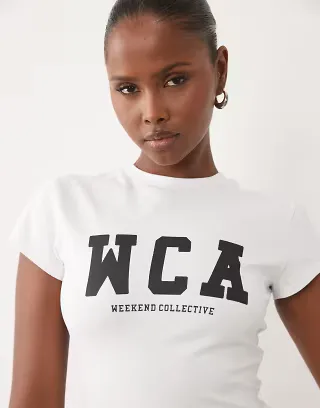 Weekend Collective Icon baby tee with WCA graphic in white