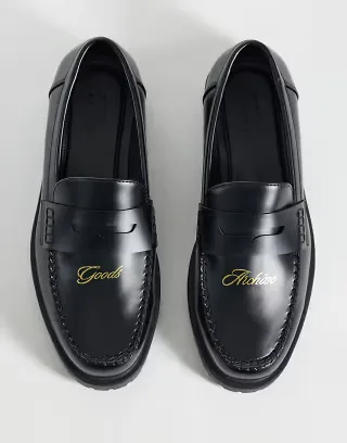 ASOS DESIGN loafers with embossed text and cleated sole in black