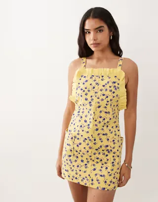 ASOS DESIGN pinny mini dress with pockets and ruffles in blue ditsy print